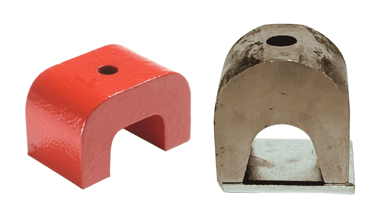 Two U-shaped magnets, one red with a center hole and one bare metal on a flat base.