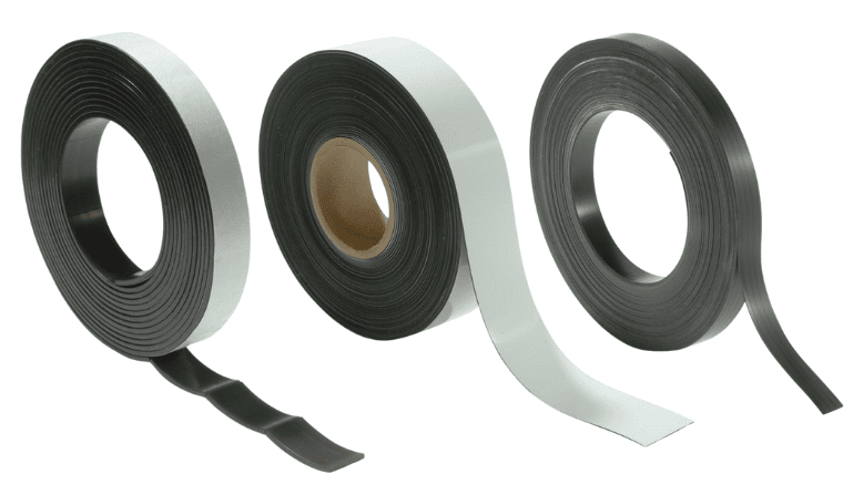 Three rolls of black adhesive magnetic strip magnets with peel-away backing on a white background.