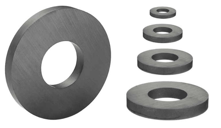 A large circular magnet with a center hole is shown beside four smaller ring magnets arranged in a line.