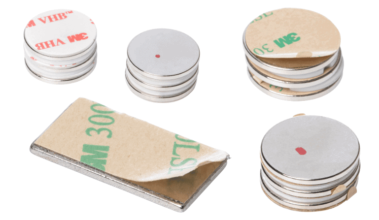 Stacks of round and rectangular neodymium magnets with peel-off adhesive backing strips