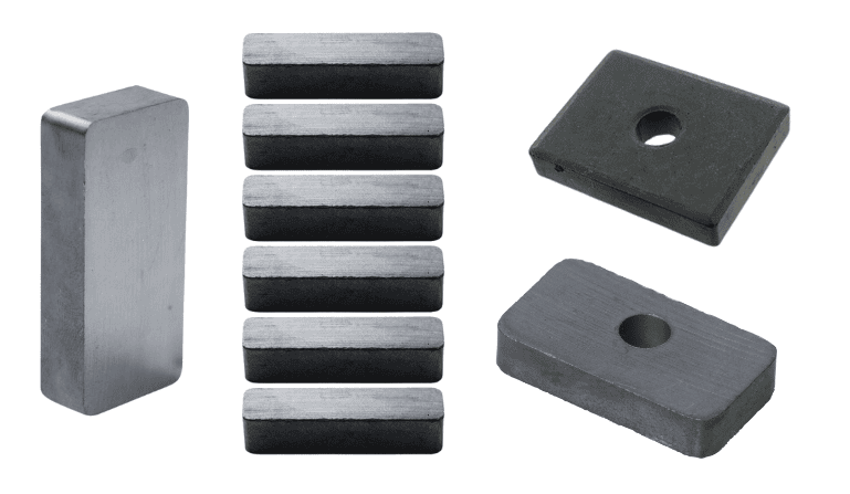 Various rectangular magnets, including solid bars and pieces with center holes, are grouped together.