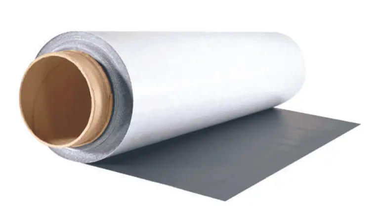 Flat black magnetic sheet lying on a cutting surface.