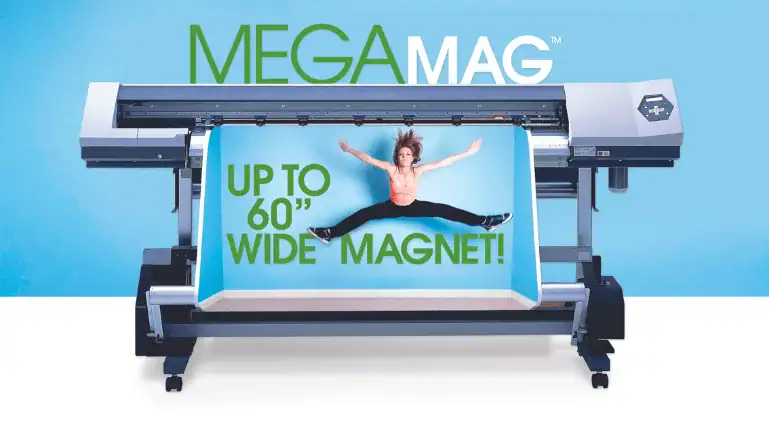 Large roll of dark flexible sheet material unfurling across a wide printer table.